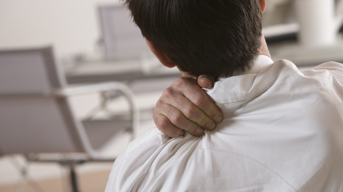 Businessman massaging shoulder