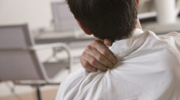 Businessman massaging shoulder