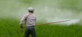 farmer applying pesticides to field