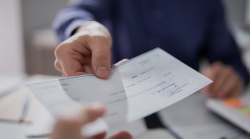 Lawyer handing over a settlement check