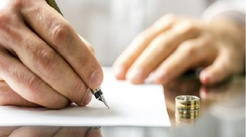 man signing document