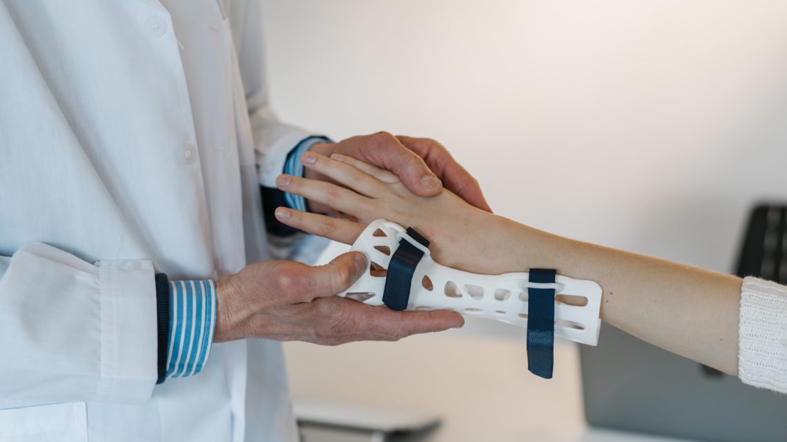 doctor putting a brace on someone's wrist