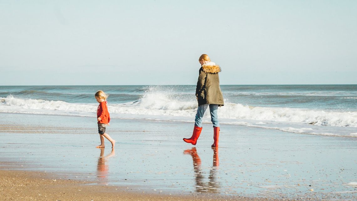 child & mom on a beach