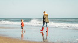 child & mom on a beach