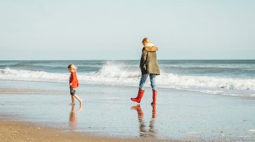 child & mom on a beach