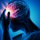 Cartoon Rendering of man with a brain injury. The brain is visible with a radiating red light where the pain is.