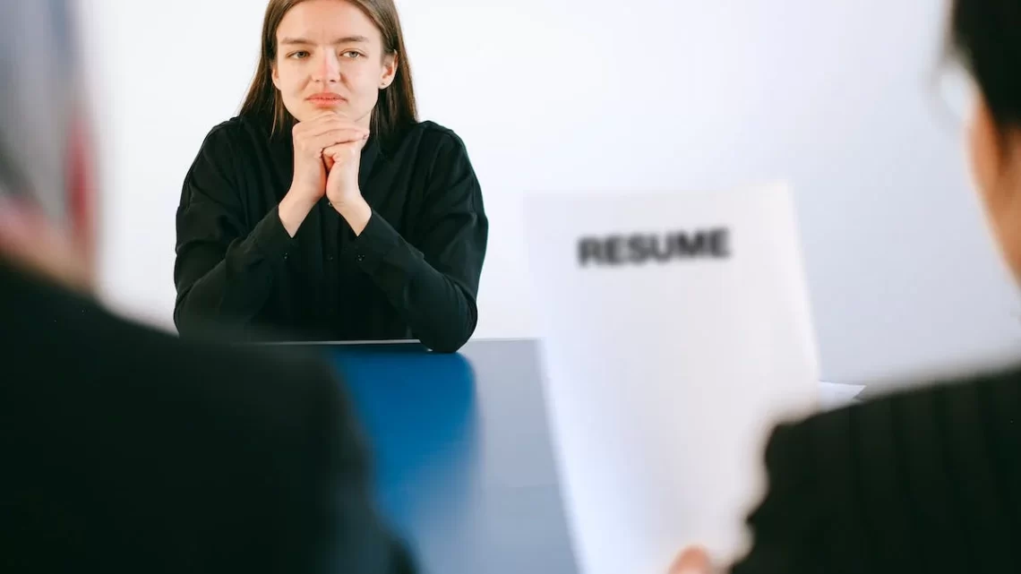 an employer looking over a female applicant's resume