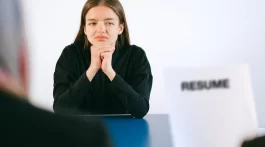 an employer looking over a female applicant's resume