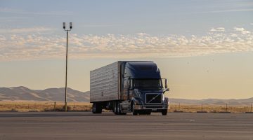 truck in a desert with sunset